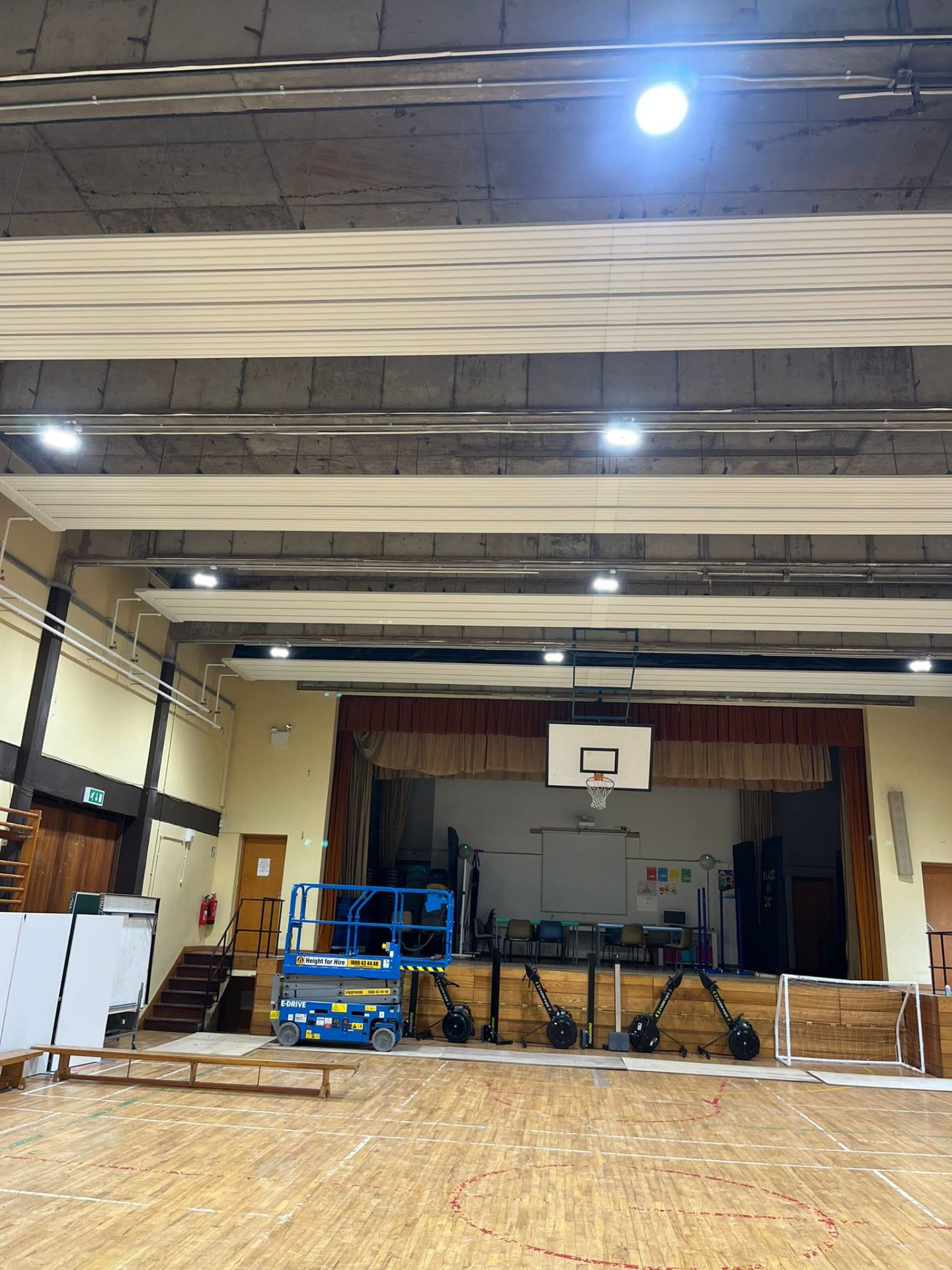 Sports hall lighting from stage end