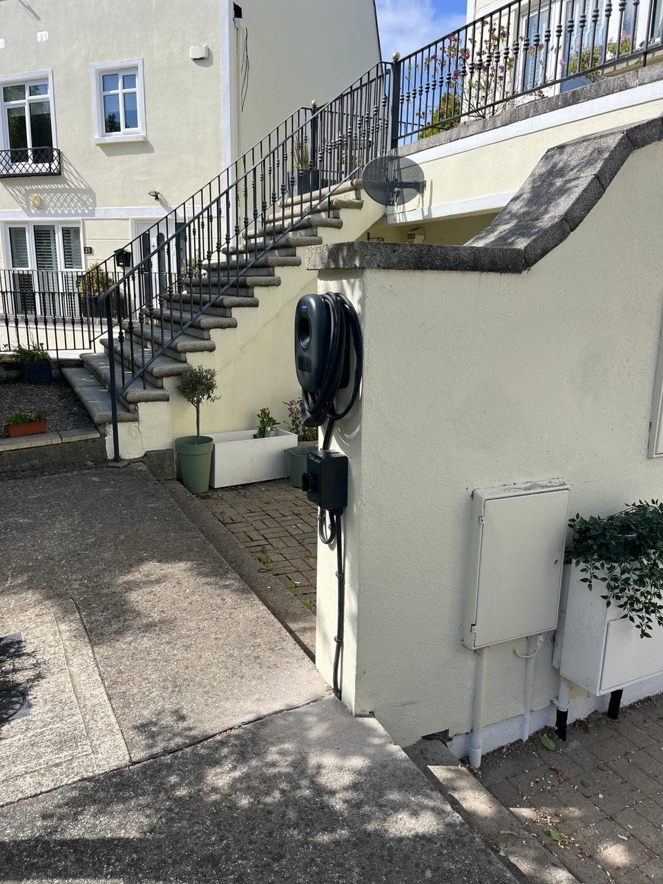 EV charger mounted on driveway wall