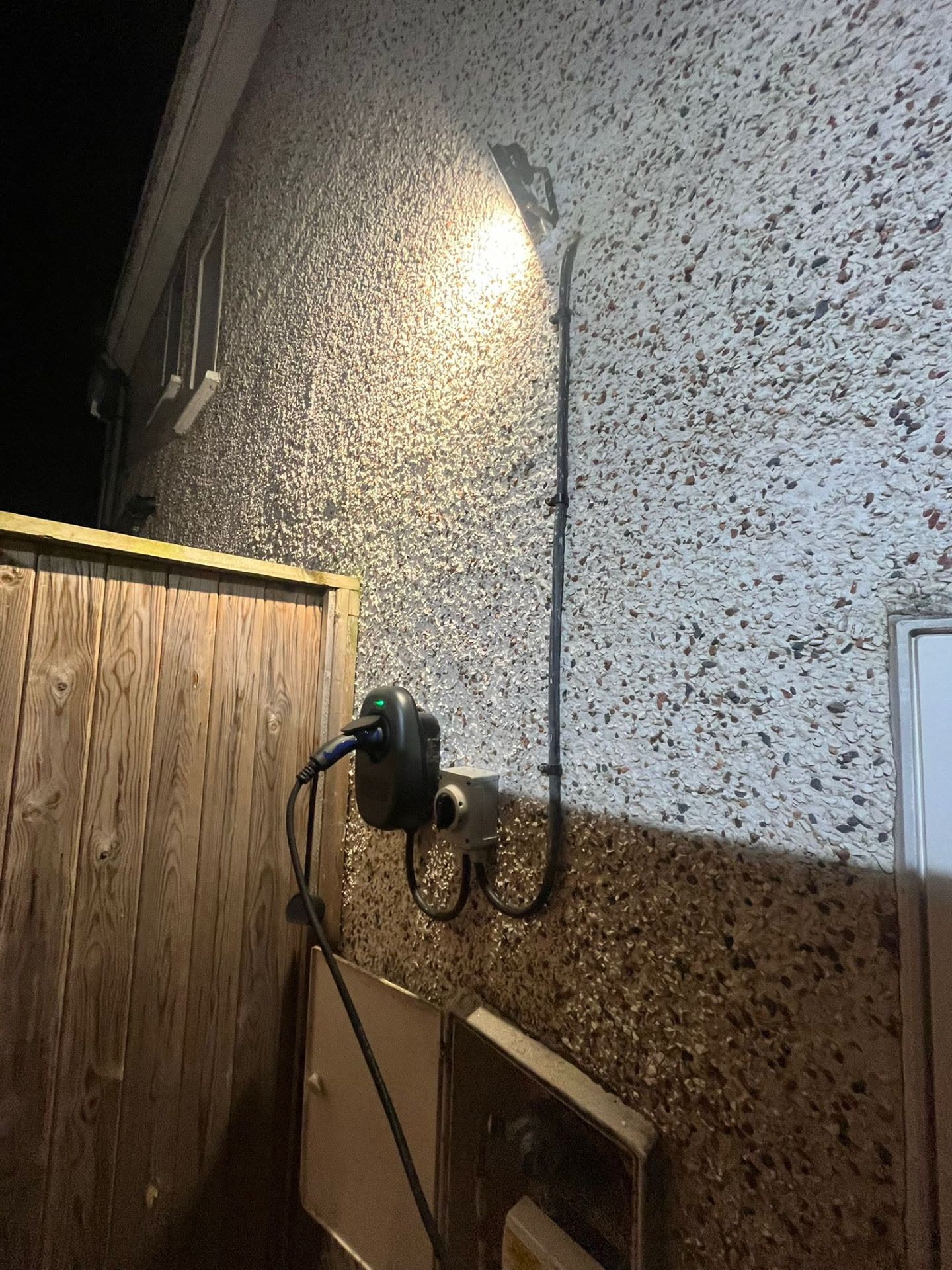 EV charger exterior installation at night
